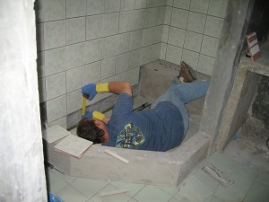 Andrew tiling the bathroom