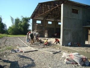 Pouring cement in front of the hangar