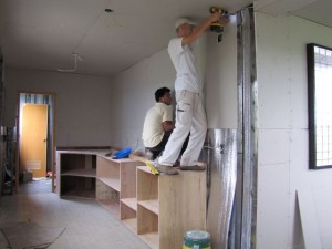 Andrey hanging drywall in the future kitchen