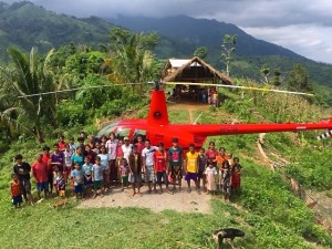 Villagers of Karusuan with Wendy (and the all purpose building they built in background)